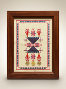 Framed Palestinian tatreez sampler with coins